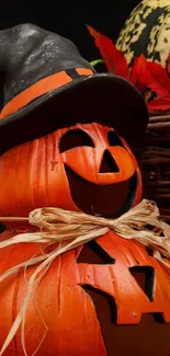 Halloween jack-o'-lanterns with witch hat and autumn leaves.