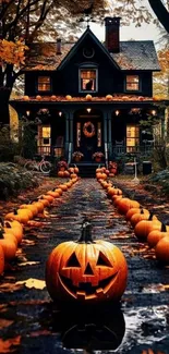 Halloween wallpaper with pumpkins lining the path to a charming house.