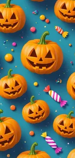 Halloween wallpaper with pumpkins and candies on teal.