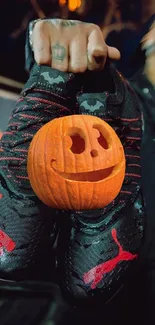 A carved pumpkin smiles on black shoes with red accents, perfect Halloween vibe.