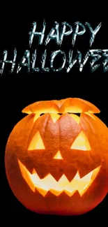 Tech-inspired Halloween wallpaper with glowing jack-o'-lantern above laptop.