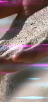 Hand pouring sand with neon streaks in vibrant wallpaper.