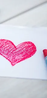 Hand-drawn pink heart with crayon on white paper.