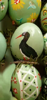 Closer look at artistically painted Easter eggs in light green hues.