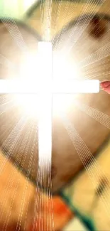 Two hands reaching towards a lit cross with heart shapes in the background.