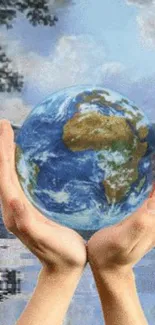 Hands holding Earth with water reflection background.