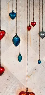 Colorful hanging heart ornaments on a textured wall background.