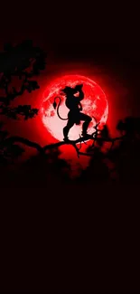 Silhouette of Hanuman with a red moon background.