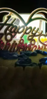 Happy Anniversary text with colorful cake decorations in the background.