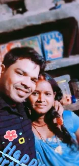 Couple smiling with a happy birthday message in colorful background.