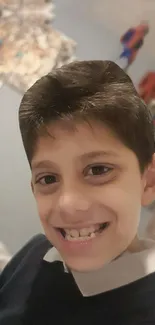 Smiling child with superhero figurines in the background.