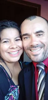 Smiling couple showcasing happiness in a colorful portrait.