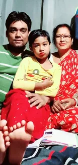 Family portrait indoors with colorful attire.