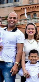 Joyful family portrait outside with smiling parents and children.