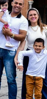 Happy family standing outdoors in casual attire.