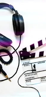 Black headphones and clapperboard on white background wallpaper.