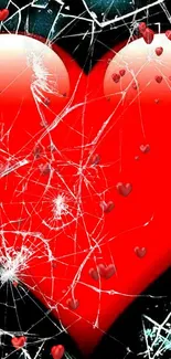 Red heart with shattered glass on a dark background.