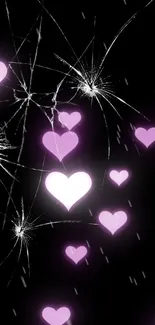 Mobile wallpaper with pink hearts and cracked screen on black background.