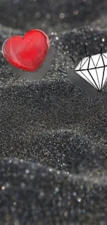 Red heart and diamond on glittery black surface.