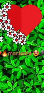 Red heart with flowers on vibrant green leaves background.