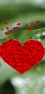 Red heart with small hearts on green leafy background.