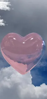 Pink heart balloon floating among clouds in a blue sky.