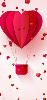 Heart-shaped red balloon over pink background with small hearts.