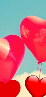 Red heart balloons floating in blue sky.