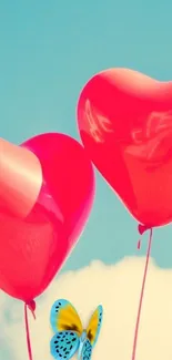 Heart-shaped balloons and butterfly in a clear blue sky.