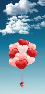 Heart balloons floating in a blue sky with clouds.