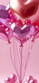 Pink heart-shaped balloons on soft pink background.