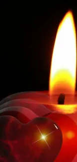 Romantic red heart-shaped candle flame wallpaper for mobile.