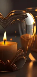 Heart-shaped glass with glowing candle in amber tones.