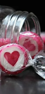 Pink heart-shaped candy spilling from a jar.