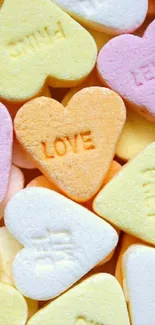 Colorful heart-shaped candies with sweet messages in pastel colors.