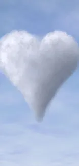 Heart-shaped cloud floating in a light blue sky.