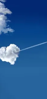 Heart-shaped cloud with airplane in blue sky.