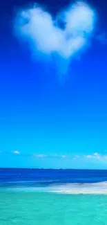 Heart-shaped cloud above a blue ocean under a clear sky.