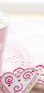 Heart-shaped cookies with pink cup on pastel background.