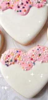 Heart-shaped cookies with pink icing and colorful sprinkles, perfect for mobile wallpaper.