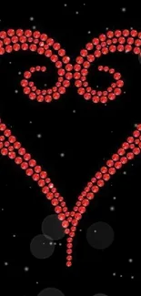 Red gemstone heart design on black background.