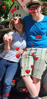 Couple smiling with red hearts overlay in a charming outdoor setting.