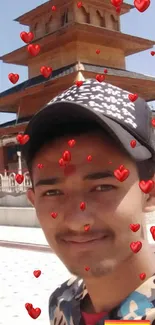 Person smiling in front of temple with red heart overlays.