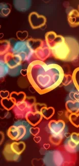 Orange and pink glowing hearts wallpaper with bokeh effect.