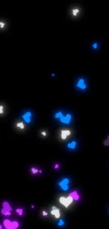 Glowing pink, blue, and white hearts on black background wallpaper.