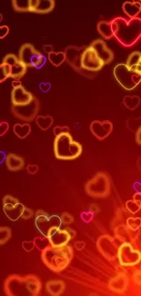 Colorful glowing heart pattern in red and yellow hues on mobile wallpaper.