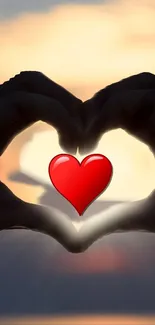 Silhouette hands forming heart with sunset background.