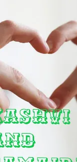 Heart formed by hands with green text overlay.