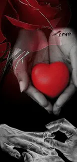 Mobile wallpaper with red heart in hands on black background.