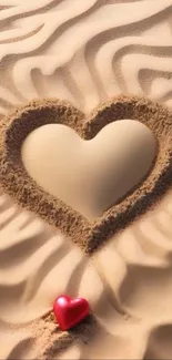 Heart shape drawn in sand with a small red heart accent.